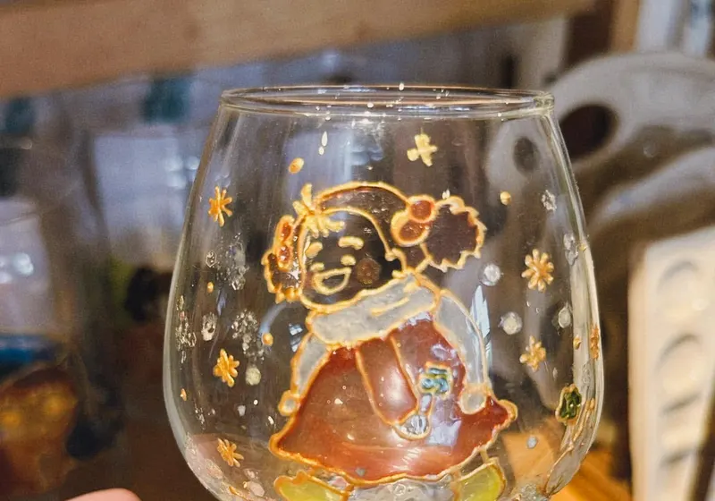 A painted wine glass finished in gold and red