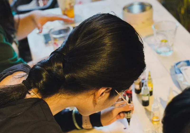 A guest concentrating on her design