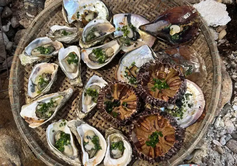 Grilled oysters, scallops and sea urchin served in bamboo trays