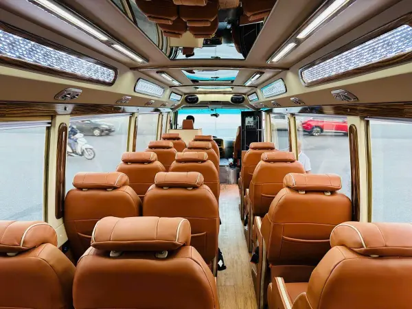Inside the 16-seat Limousine: tan leather seats under a lit ceiling