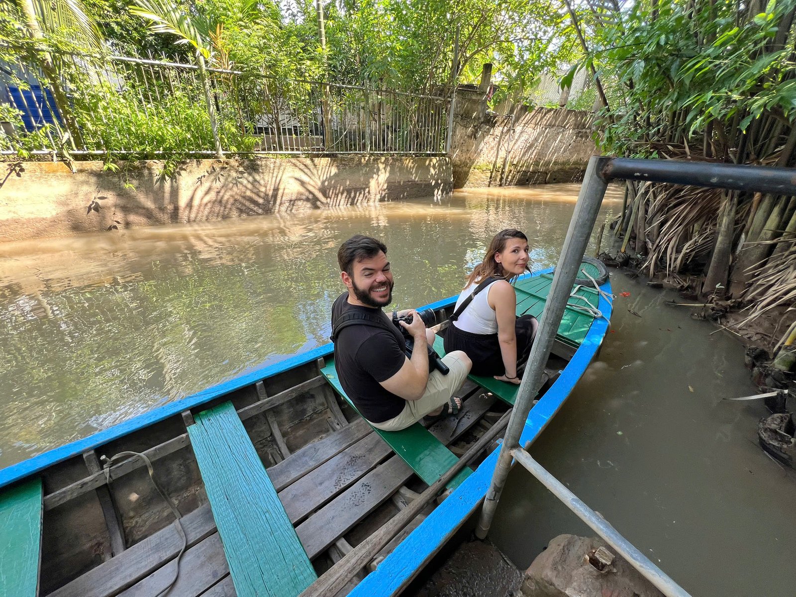 Rowing boat on a narrow Mekong coconut canal