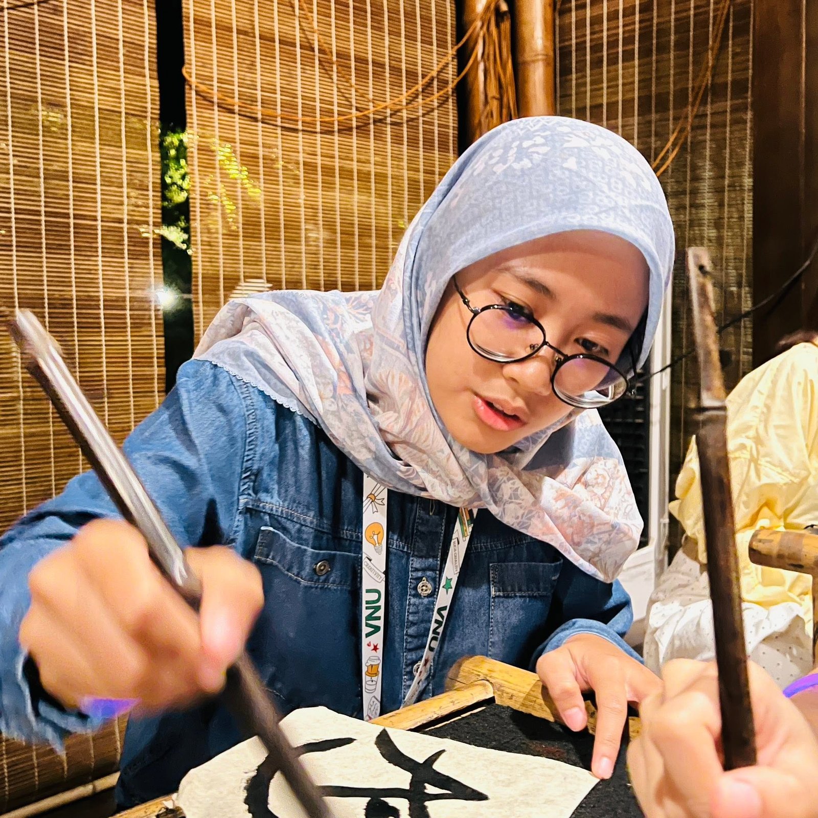 Guest trying the calligraphy experience