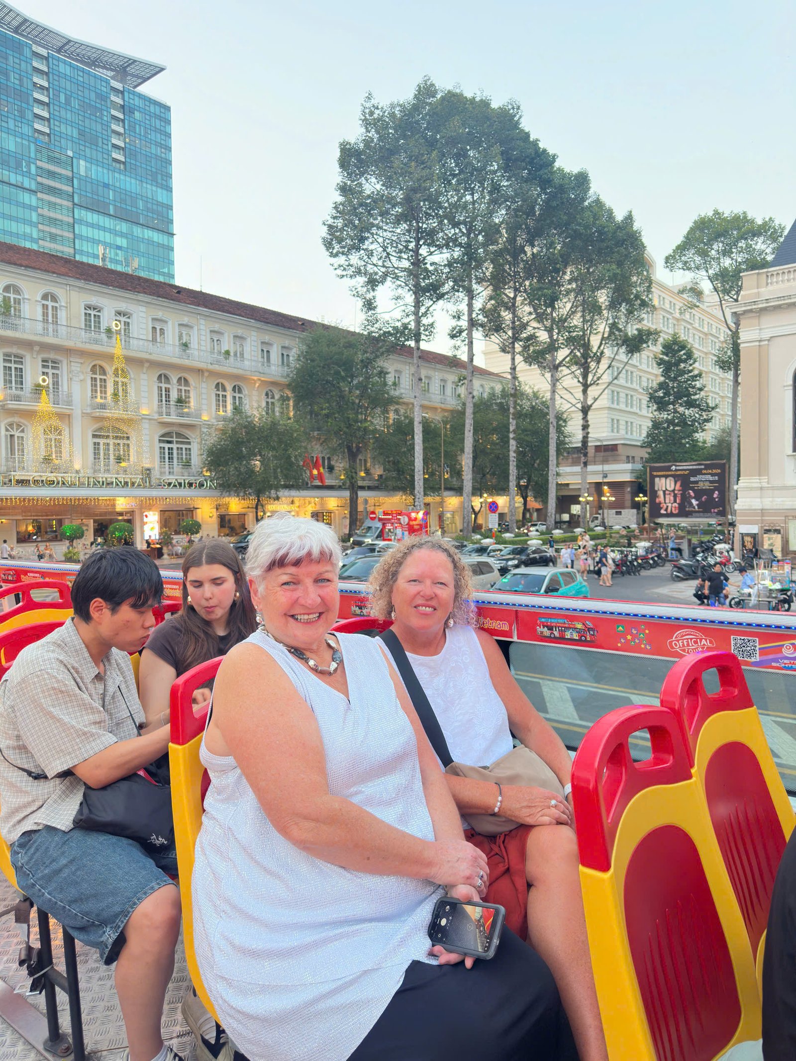 Guests on the top deck at dusk near the Hotel Continental Saigon