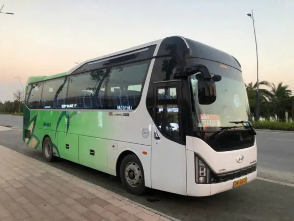 The Shuttle Bus, a white and green Hyundai coach