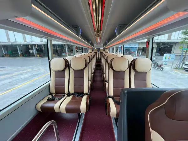 Inside the Shuttle Bus: rows of leather seats with seat belts