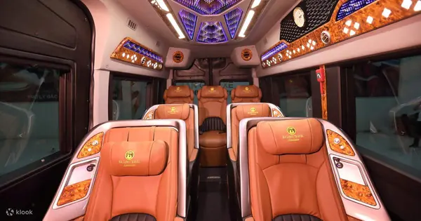 The limousine van cabin: leather captain seats under an LED ceiling