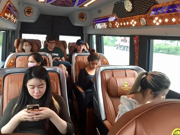 Passengers in the limousine van's tan leather seats