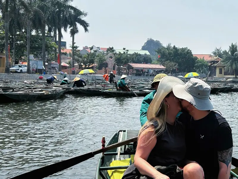 Couple on a rowing boat below the Ninh Binh karsts