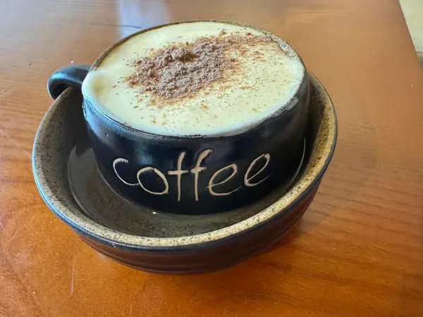 The finished Hanoi-style egg coffee, dusted with cinnamon