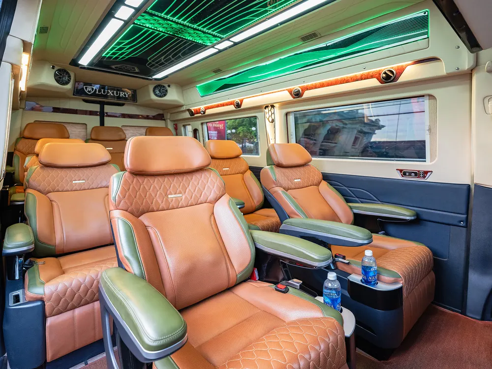 Cabin seating with armrests, cup holders and bottled water