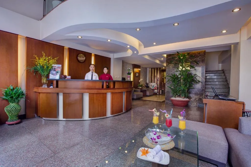 Lobby with a curved wooden reception desk under a sculpted ceiling