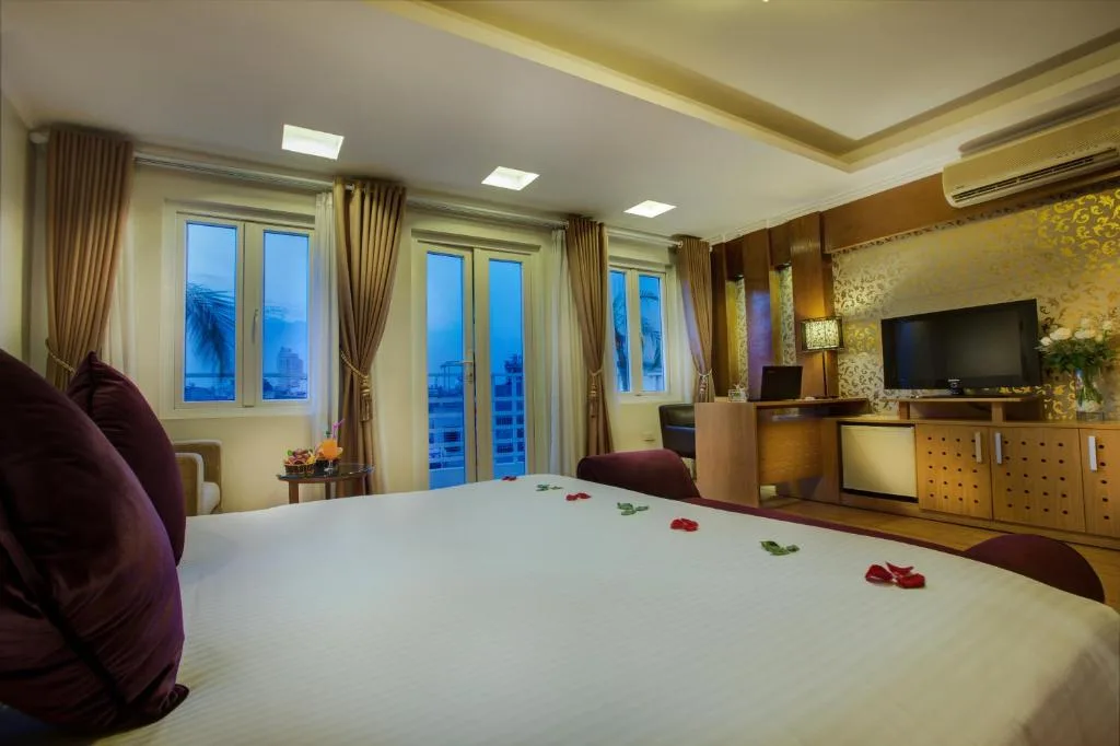 Room at dusk, with windows and balcony doors looking over the rooftops