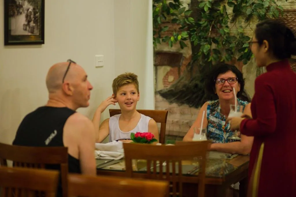 Guests at breakfast in the restaurant, served by a member of staff