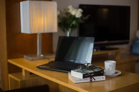 Family Suite: the writing desk with a lamp, books and coffee