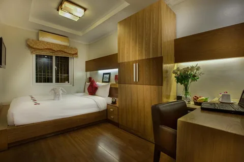 Superior Double: the bed, the wardrobe run and a desk under the window