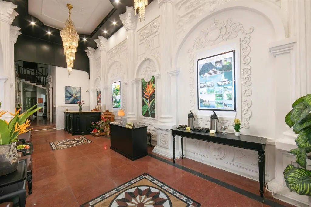 Hotel lobby with white plasterwork, chandelier and tiled floor