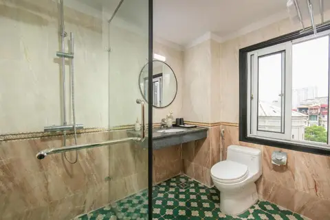 Deluxe King: marble en-suite with a walk-in shower and its own window over the city