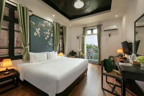 King Room with Balcony: bed under a painted magnolia panel, with French doors onto the balcony