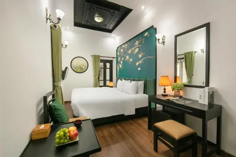 Superior room: king bed under a painted teal headboard, with desk and mirror