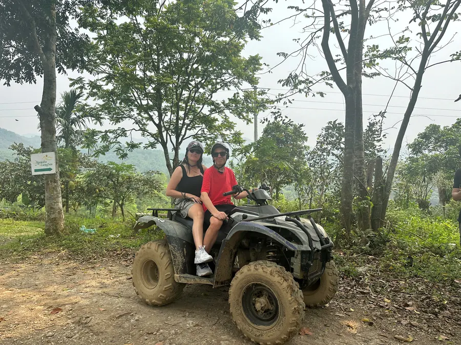 Two guests on a quad on a forest trail in Hoa Binh